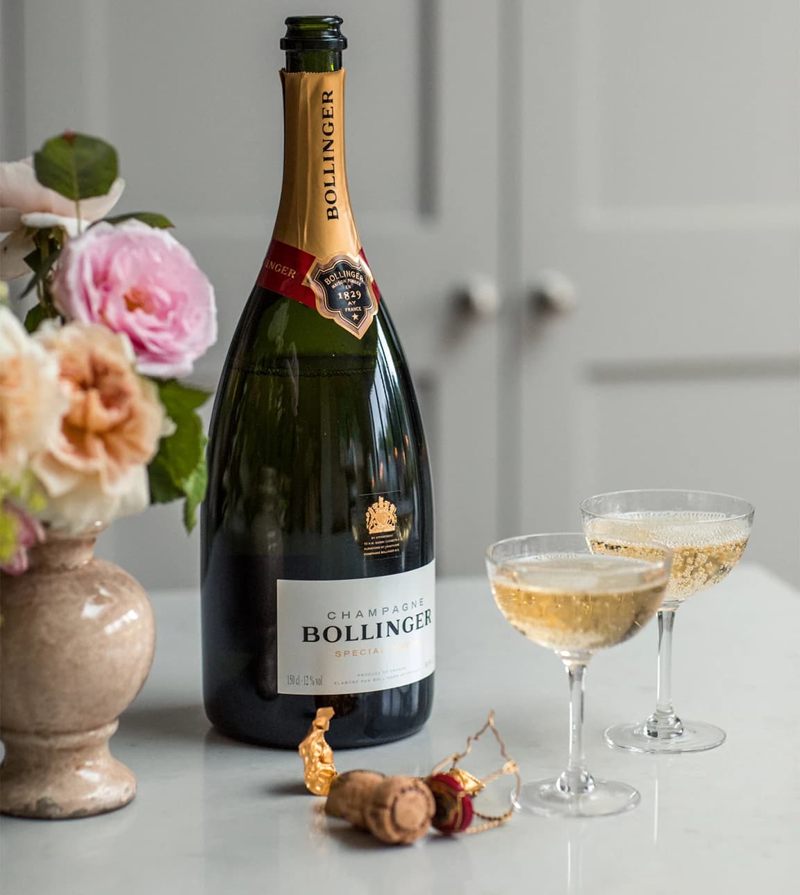 Bollinger champagne is served in luxury champagne coupe glasses from The Wedding Present Company are placed on kitchen 