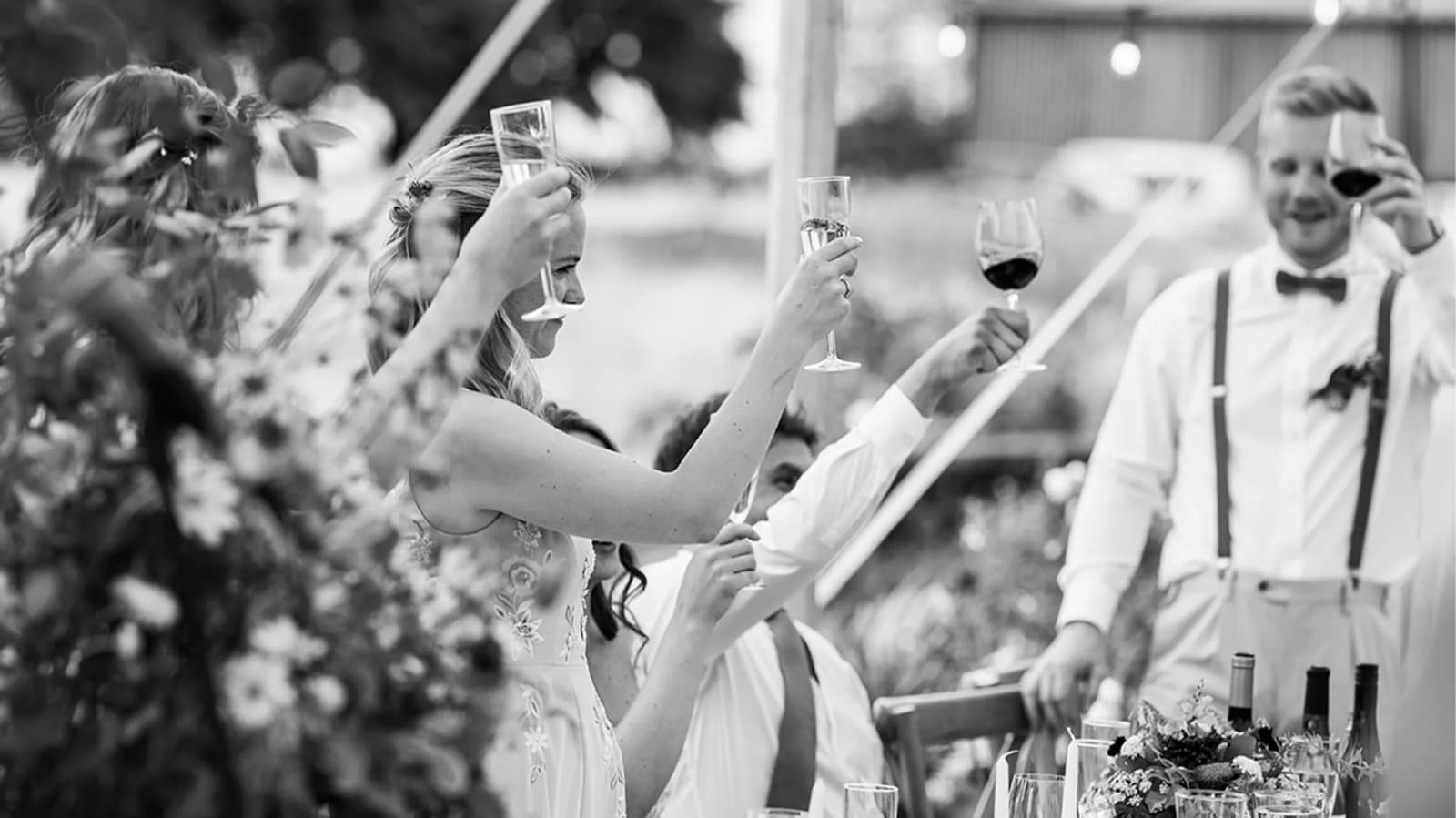 bridesmaids and groomsmen cheers for the couple