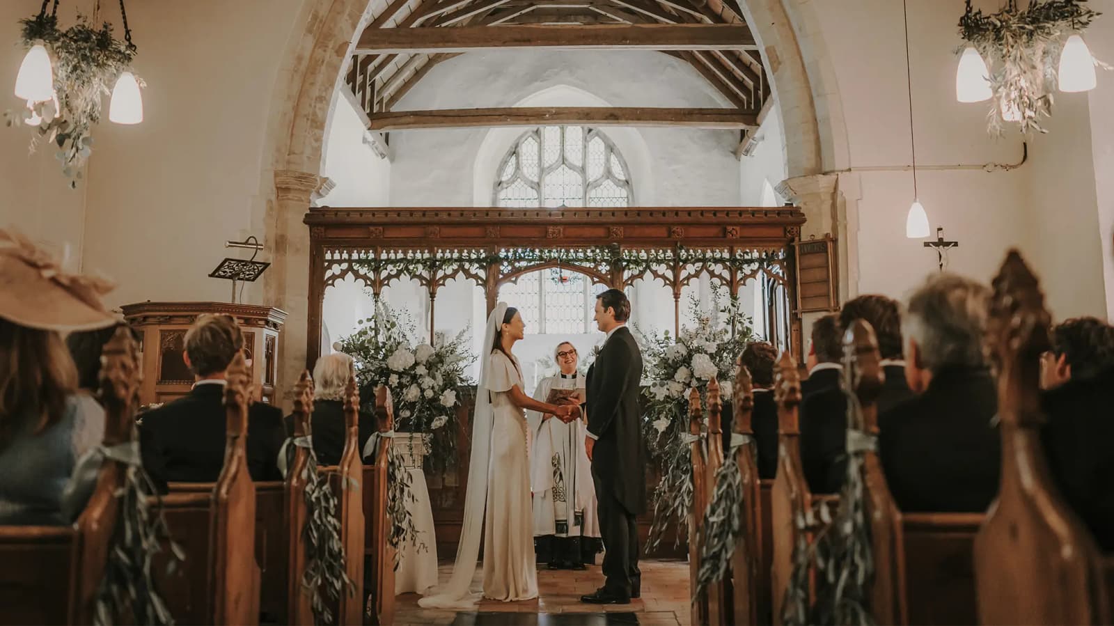 Bride and groom do wedding vows during their wedding ceremony in English church