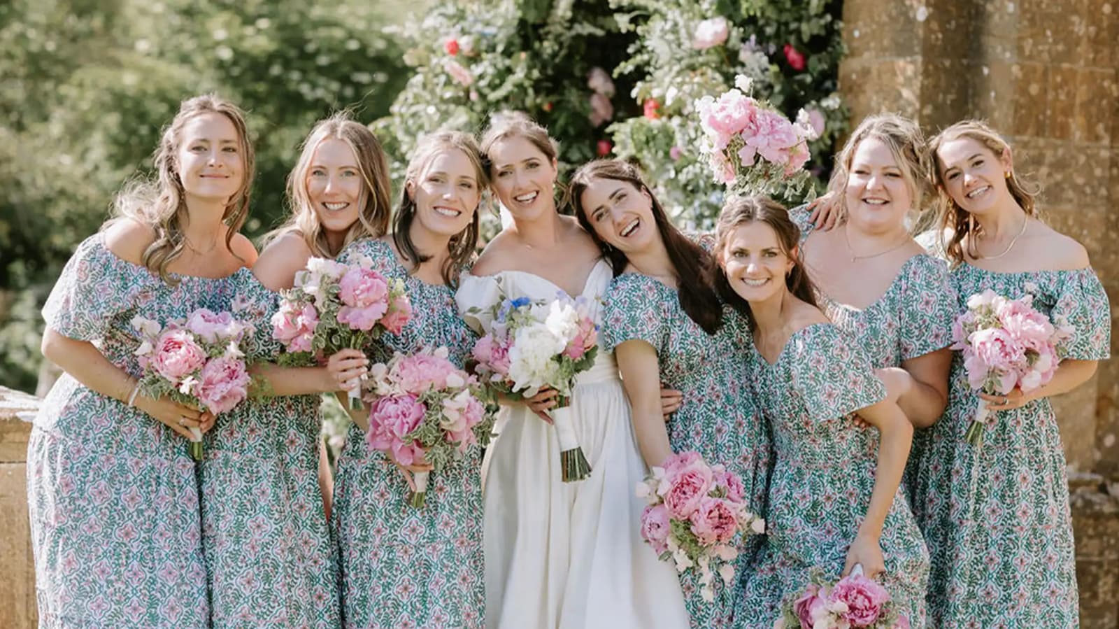 bridesmaids and bride best friends matching dresses flowers
