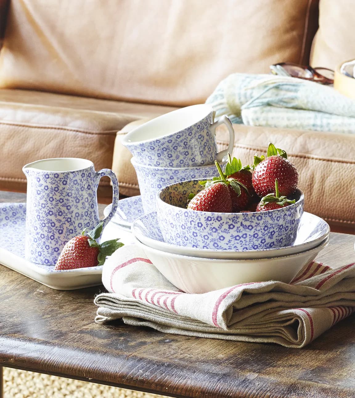 Afternoon tea and strawberries are served using wedding gifts from Burleigh, a tea set and bowls