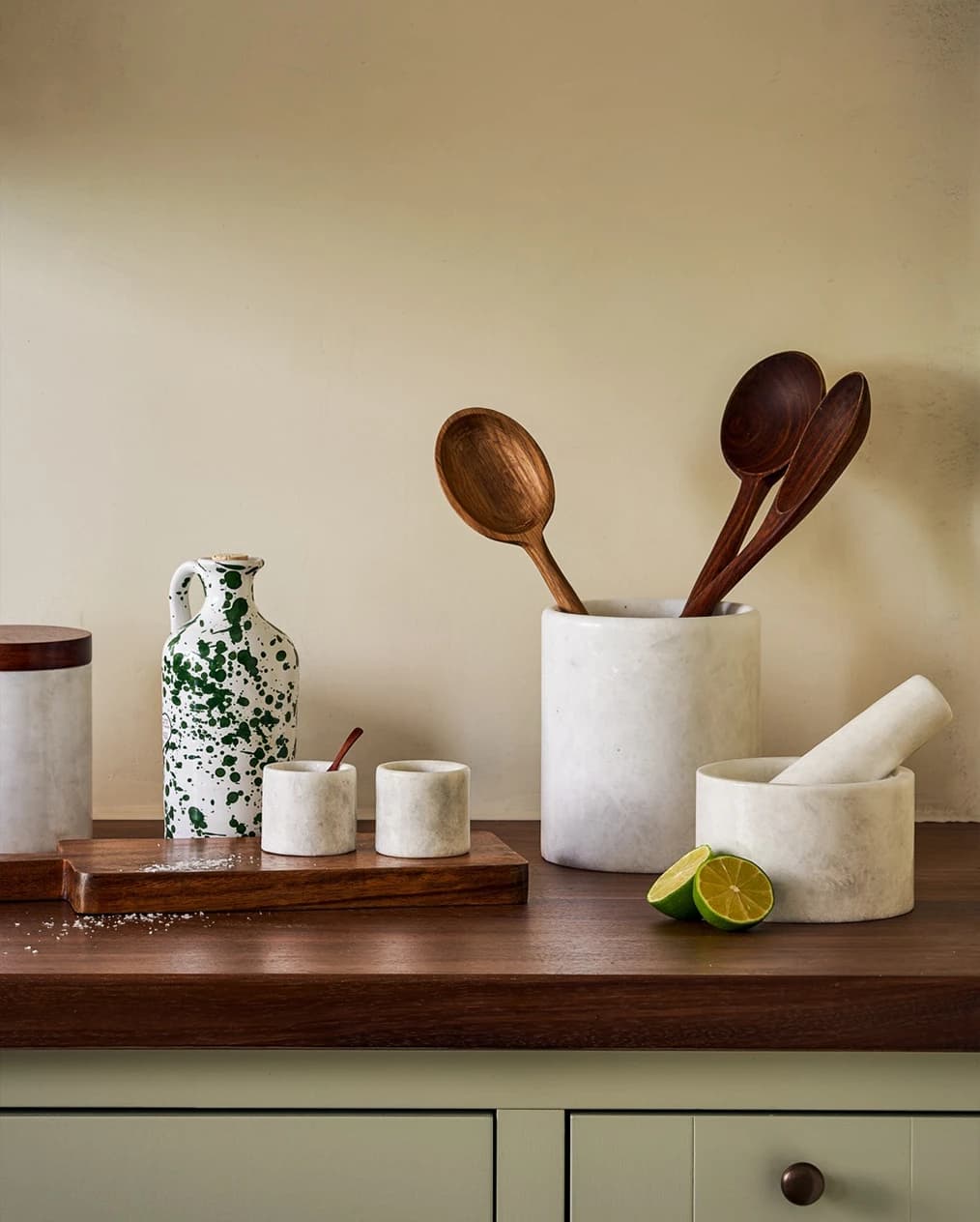 Kalinko wedding gifts for kitchen, marble utensil holder and wooden spatules, are placed on the kitchen counter