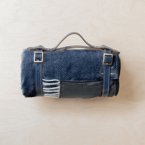 Image showing the Herringbone Recycled Wool Picnic Blanket with Brown Leather Carrier, 140 x 190cm, Navy product.