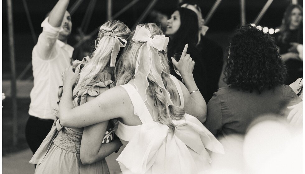 Whimsical Tuscan-Inspired Wedding in Hampshire | Bride's wavy hairstyle from the back, featuring a big bow 