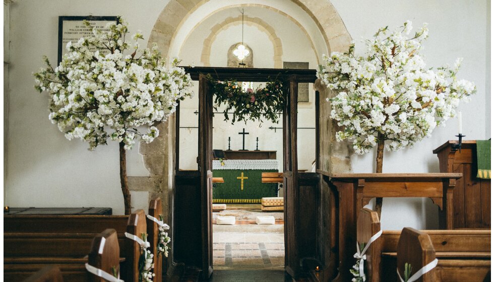 Whimsical Tuscan-Inspired Wedding in Hampshire | Tuscan-inspired wedding decoration inside traditional church w