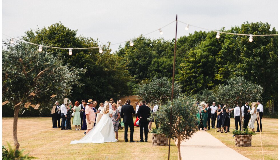 Whimsical Tuscan-Inspired Wedding in Hampshire | Bride, groom and guests at a Tuscan-inspired wedding party at a garden venue in Hampshire