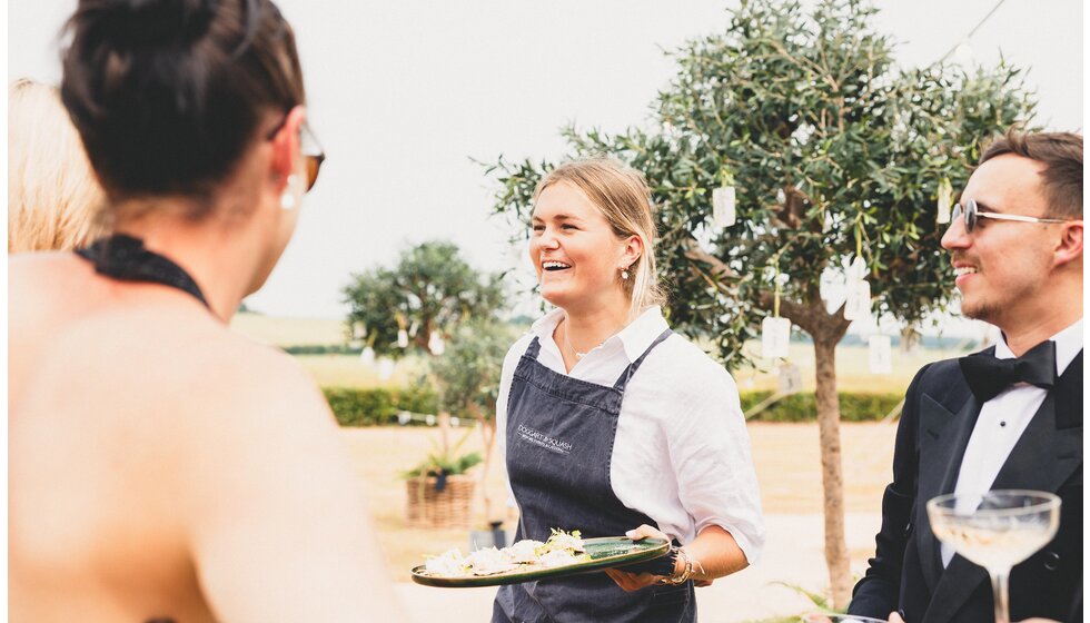 Whimsical Tuscan-Inspired Wedding in Hampshire | Waitress offering a seasonal & locally sourced wedding catering service from Doggart & Squash 
