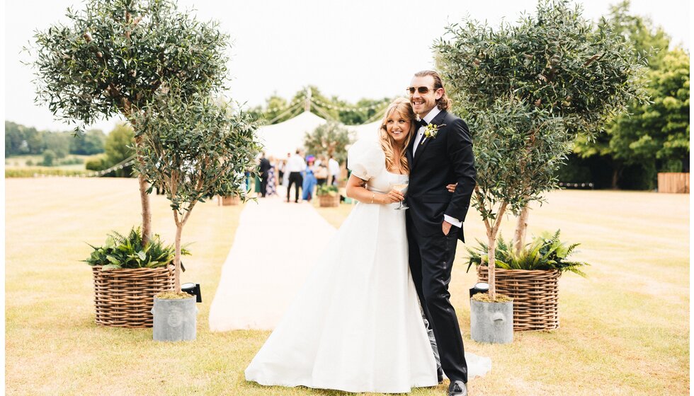 Whimsical Tuscan-Inspired Wedding in Hampshire | Bride and groom outside their beautiful wedding marquee in Hampshire