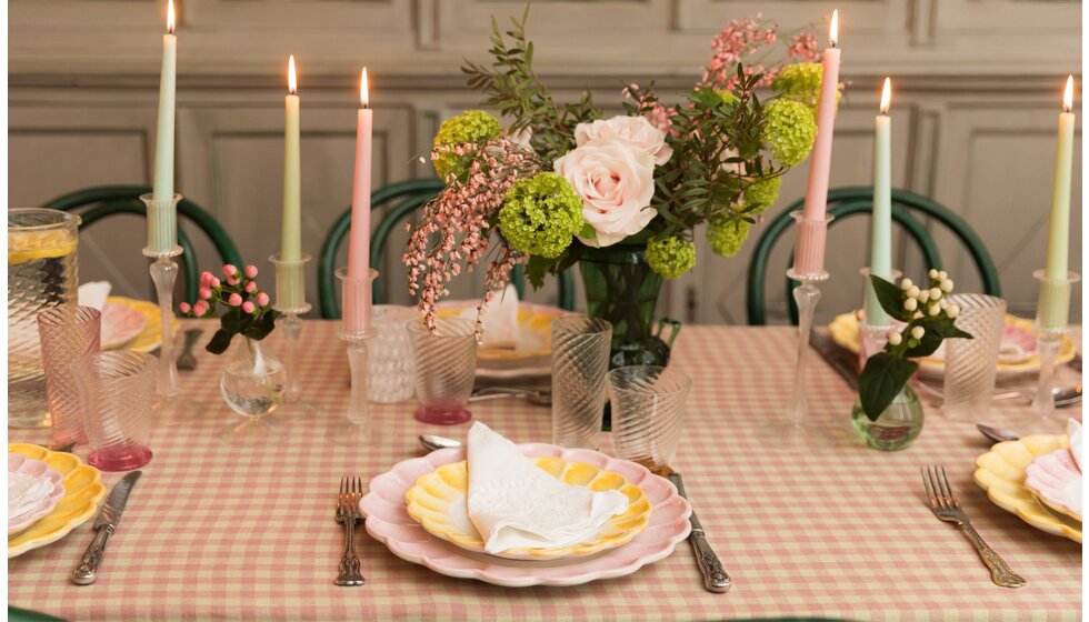 Supper Club with Skye McAlpine | Pink and yellow table decor and setting on a gingham tablecloth, featuring pastel coloured crockery, seasonal flowers in vase and candles in glass candlesticks