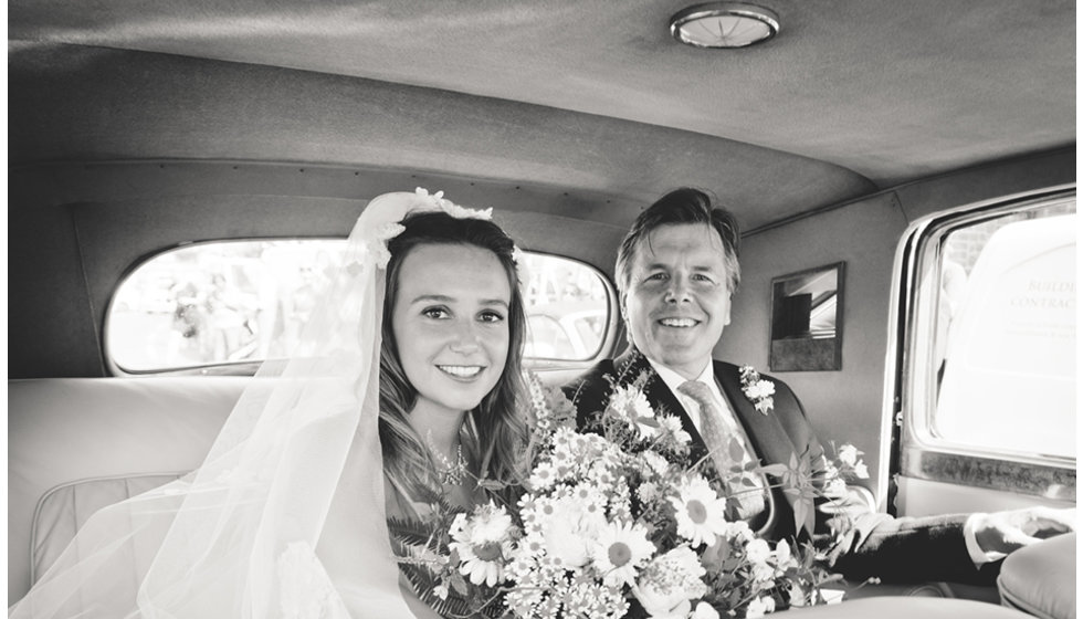 Daisy and her Father on the way to the Church in the back of a vintage car.