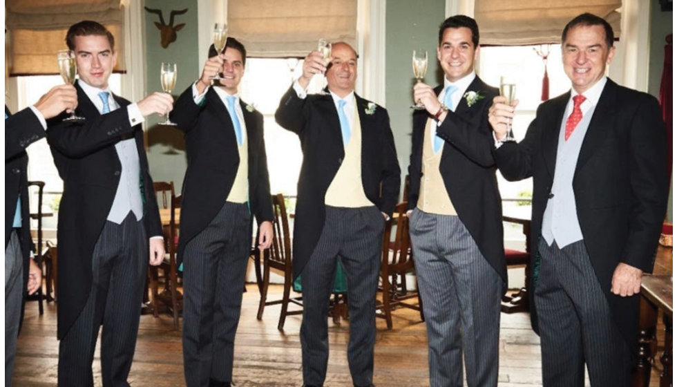 The groom and his men raising a glass to the occasion