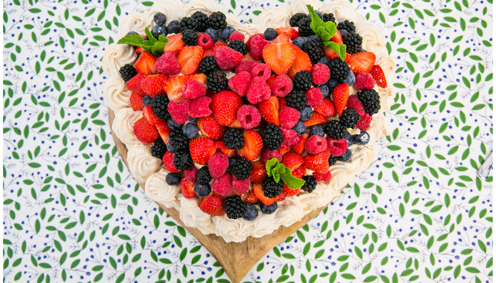 Heart-shaped pavlova served covered in berries was for desert. 