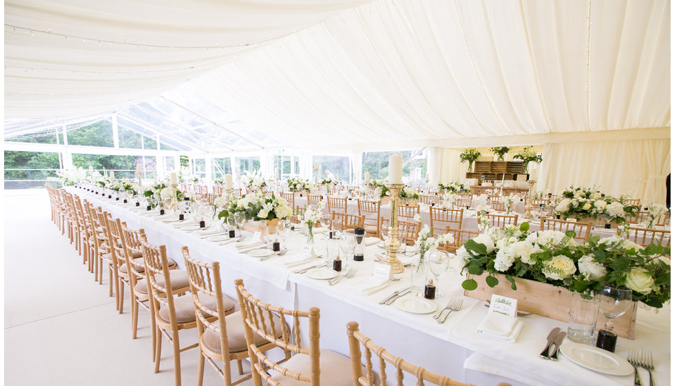 The tables all laid inside the marquee.