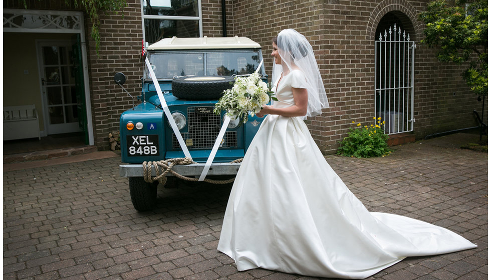 Min in front of the couple's wedding transport - an old Land Rover.