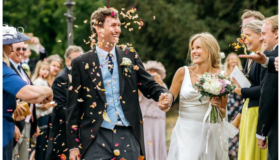 Confetti shot of Jo and Sam. Jo wore a traditional morning suit with a pale blue waistcoat.