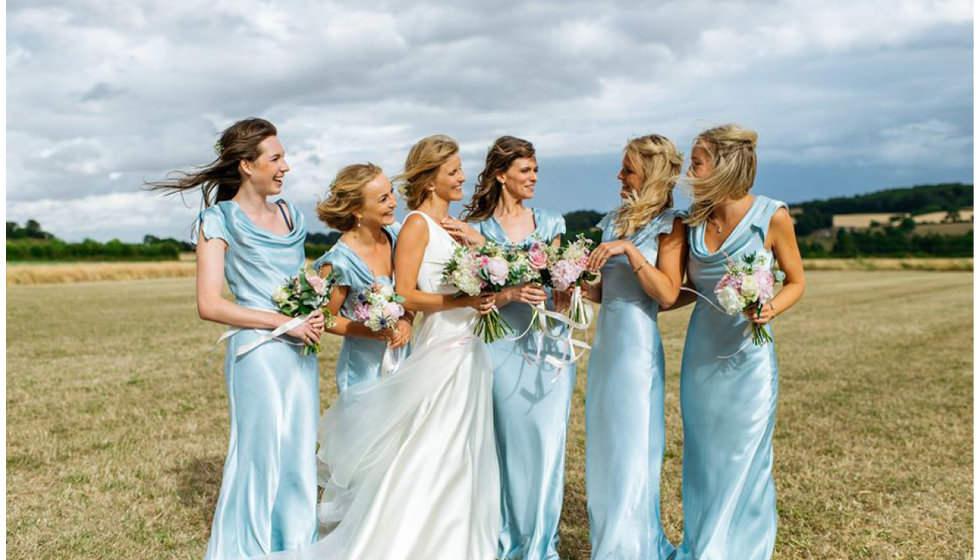 Jo and her five bridesmaids all wearing baby blue long dresses from Ghost.