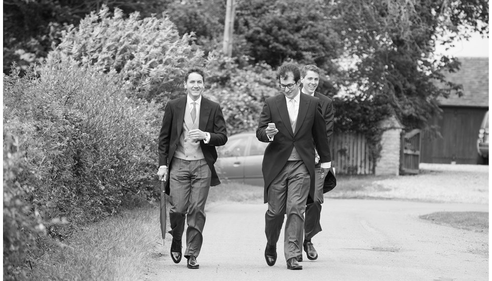 The groom and his ushers walking to the church.