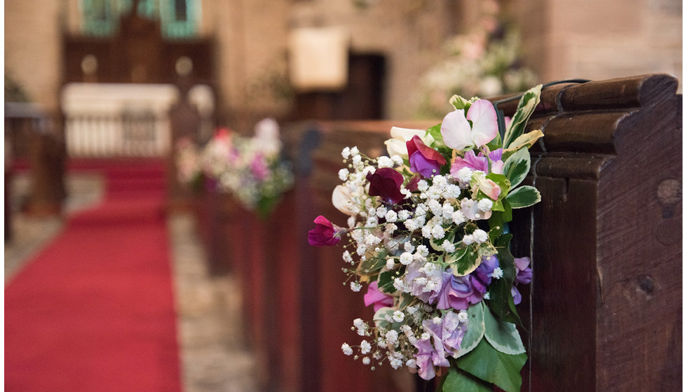 Flowers in the Church in purples, pinks and whites.