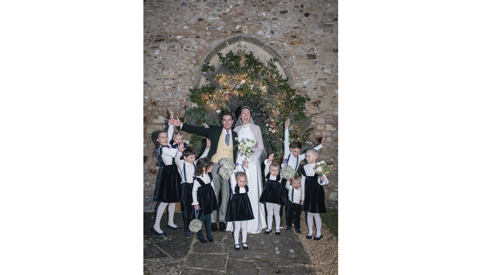 Bride and groom with their bridesmaids and pageboys outside the Church.