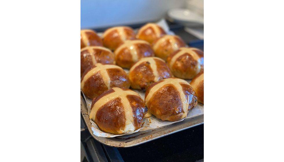 Hot cross buns that have just come out of the oven.