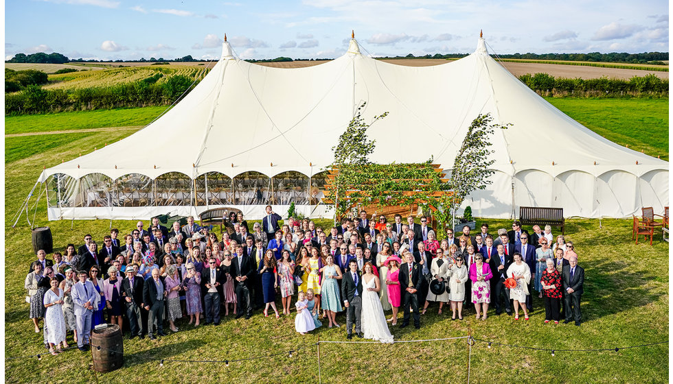 The traditional marquee from above with all the guests outside.