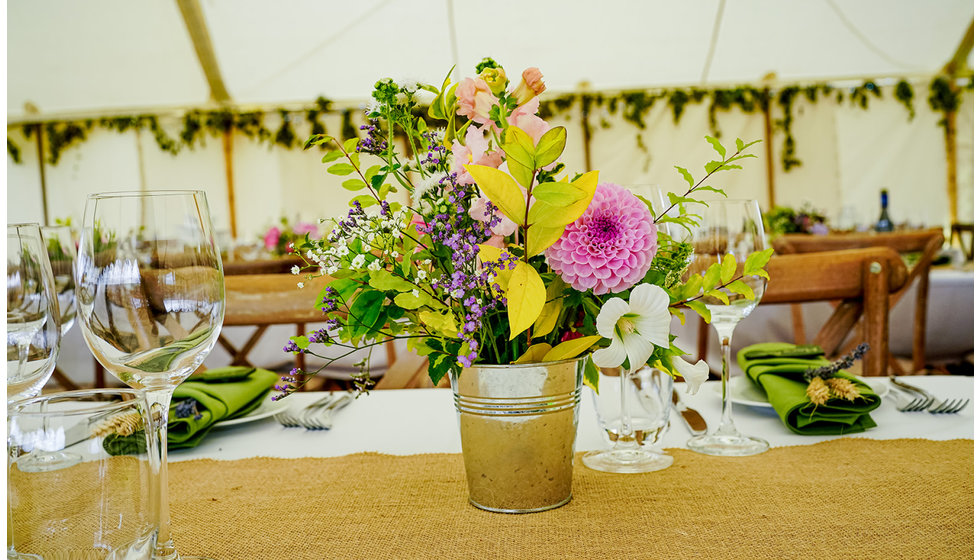 Lovely natural posy of flowers on the tables designed by Victoria's grandmother.