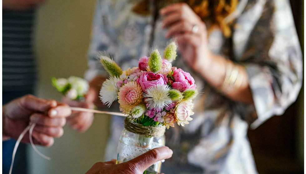 A gorgeous posy of flowers being tied up.