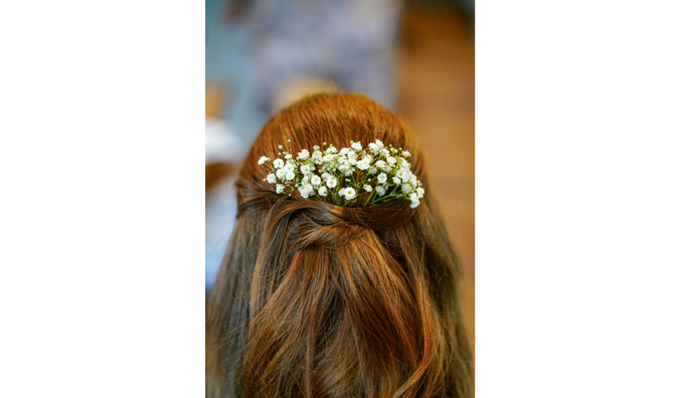 The brides hair filled with flowers.