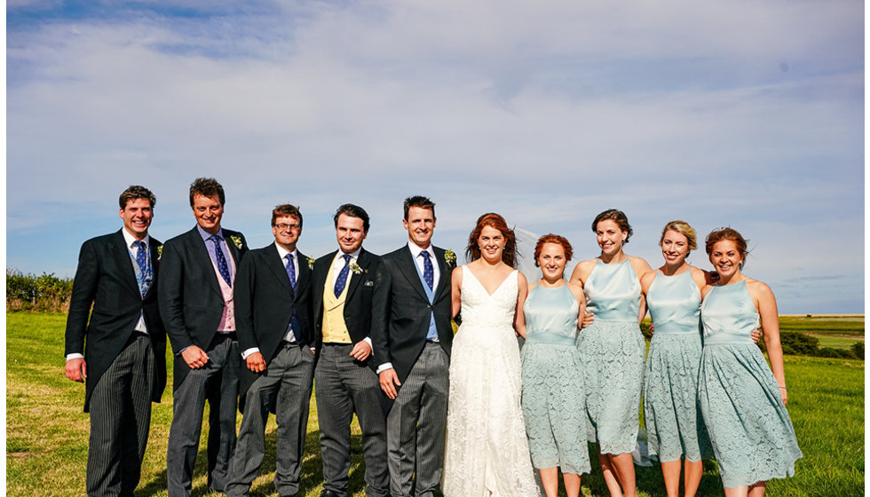 The bride, groom, the ushers and the bridesmaids.