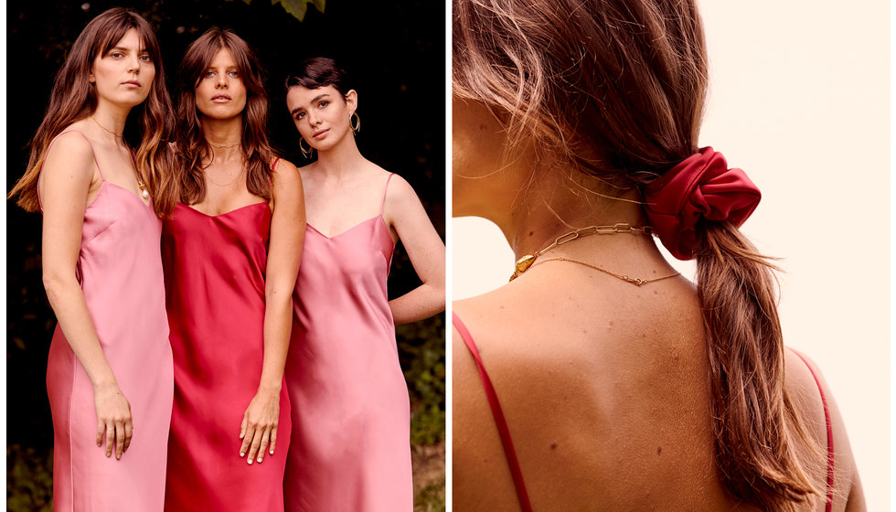 Bridesmaids wearing different shades of pink slip dresses and a scrunchie.