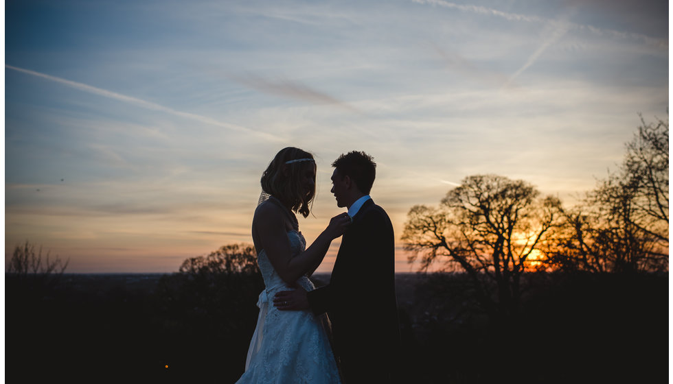 A bride and groom in winter low light.