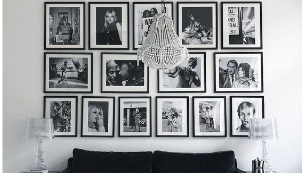 A wall of black and white framed prints from Sonic Editions.