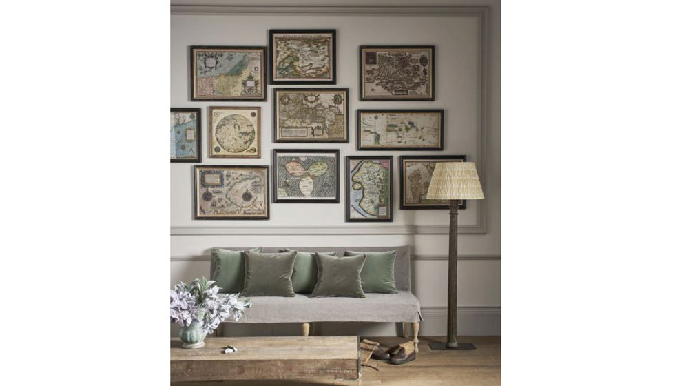 A gallery wall of framed maps from OKA.