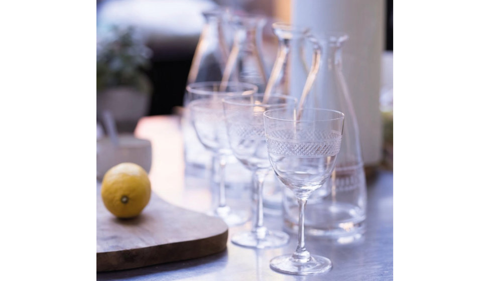 Little etched glasses from The Vintage List next to a wooden chopping board with a lemon on it.