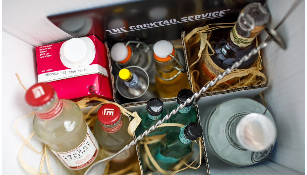 A close up of the the contents of DIY Cocktail kit including sprits, mixers and the tools.