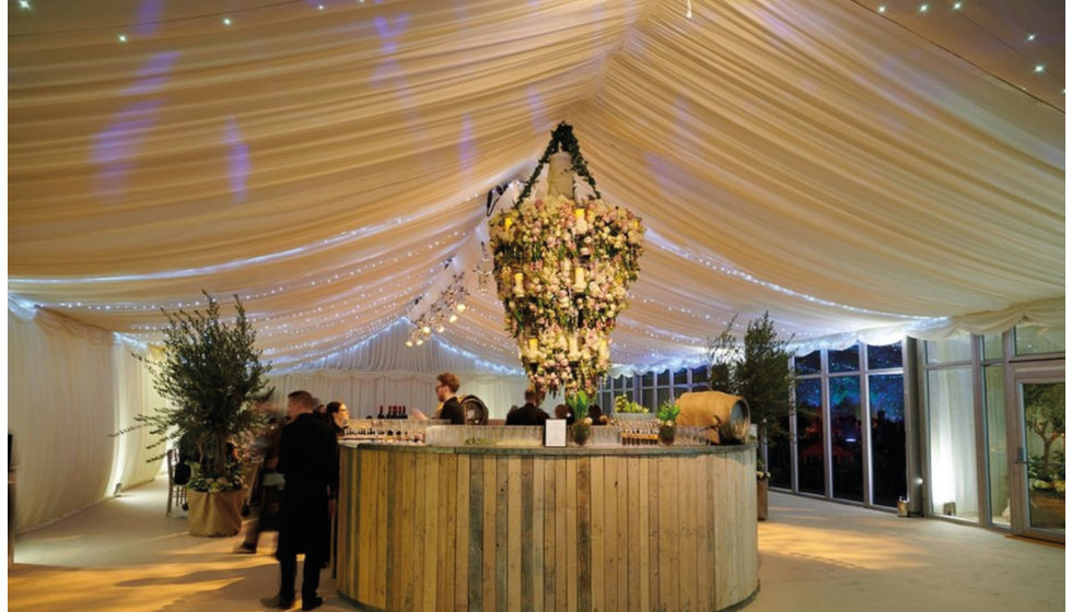 The bar with a large floral installation above.