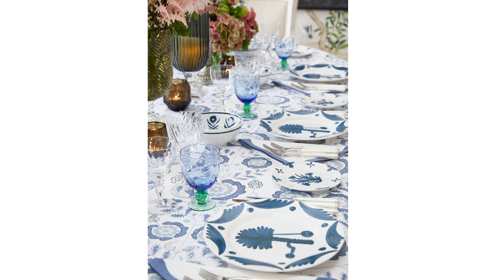 A table put together by Penny Morrison with Penny Morrison blue floral plates and a blue and white Penny Morrison tablecloth.
