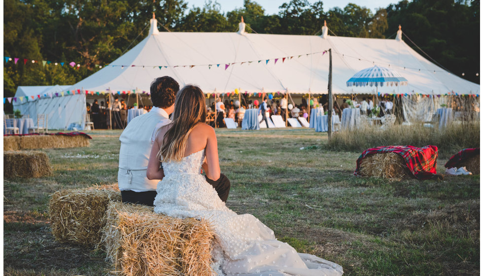 Daisy and Charlie look back on their marquee and take a moment for themselves on their wedding day.