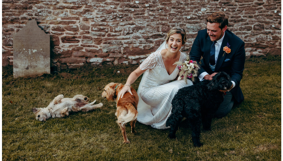 Cheskie and Rupert with their dogs outside at their wedding.