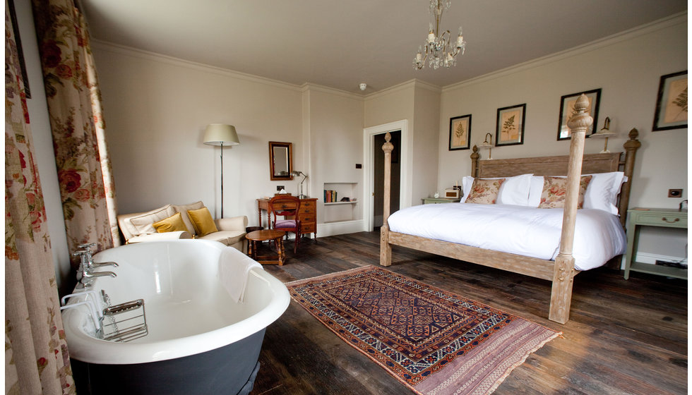 One of The Pig Hotel bedrooms with a roll top bath in the bathgroom. 