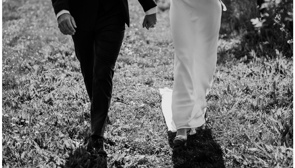 The bride and groom holding hands on their wedding day. 