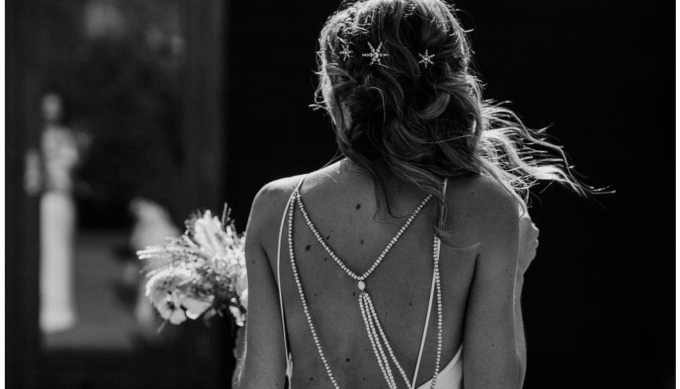 The bride wore a simple strappy wedding dress with beautiful star hair accessories. 