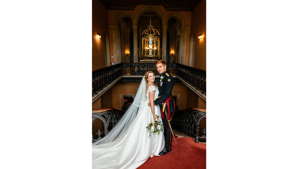 Charlotte and Matt inside their country house wedding venue for their military wedding in Summer. 