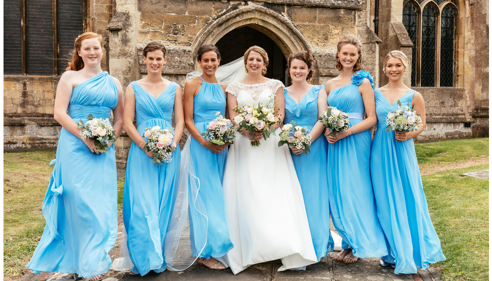 The bride and her bridesmaids. The bridesmaids wore a mixture of styles of blue dresses.