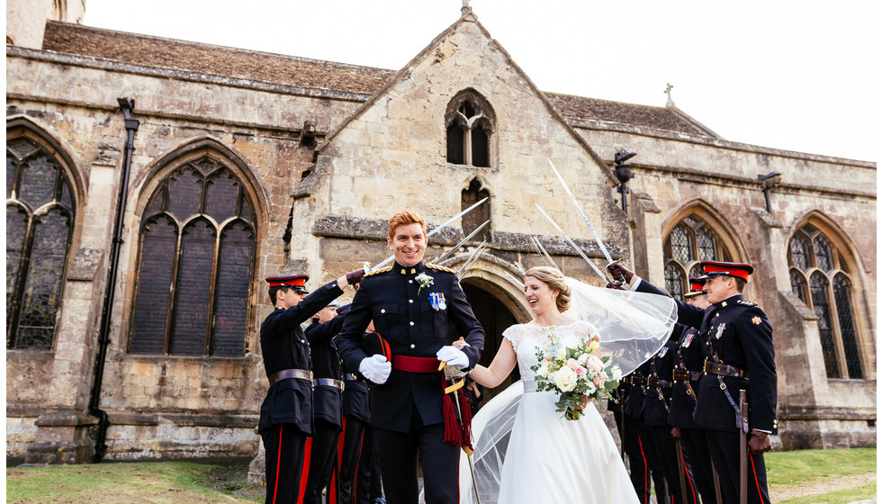 Matthew and Charlotte at their miliary wedding outside the church in Wiltshire.