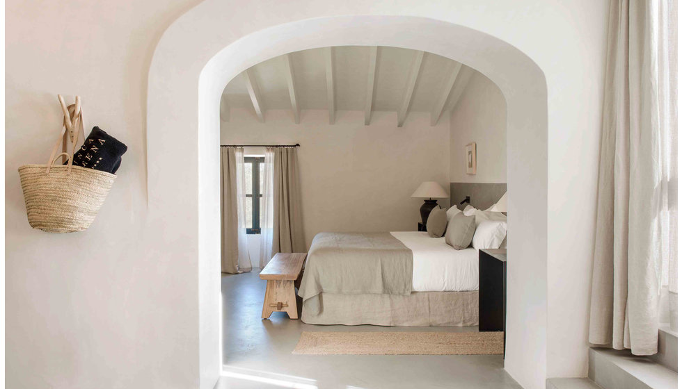 A sene and neutral bedroom at the luxury hotel Finca Serena in Malloca. 