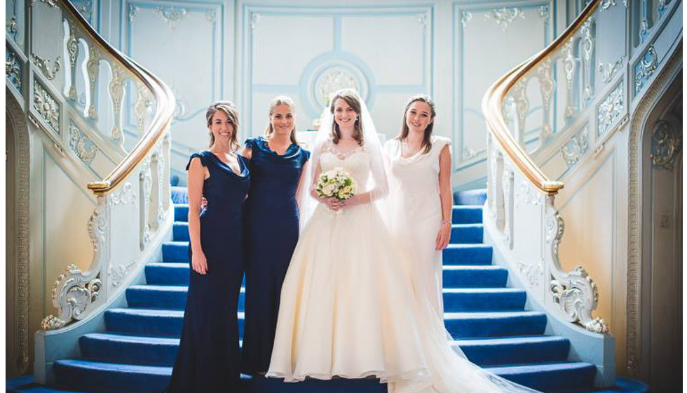 The bride, her two bridesmaids and maid of honor - standing on the steps in the Savile Club. 