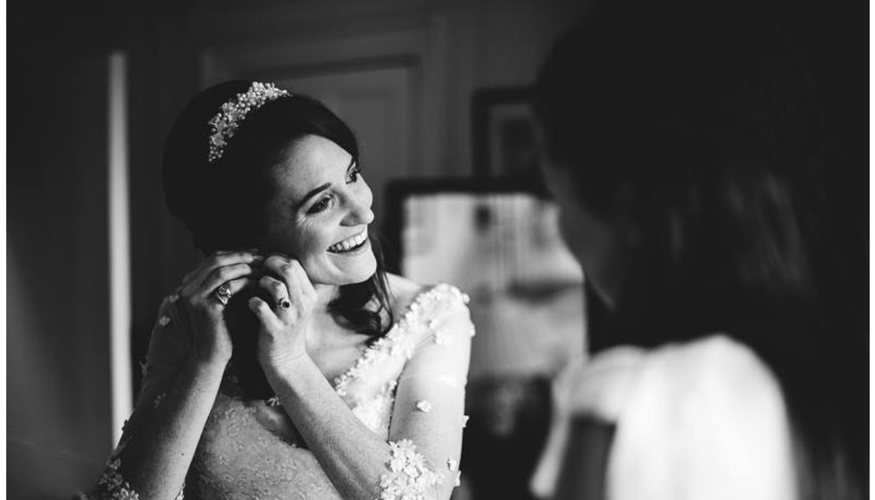 The bride putting in her earrings.