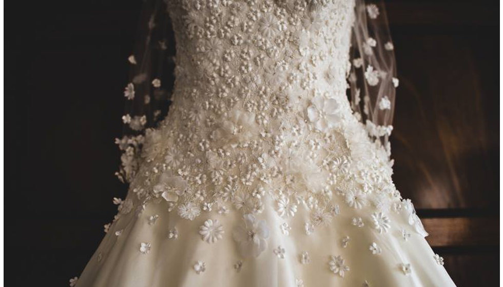 The floral detailing on the bride's sassi hollford wedding dress. 