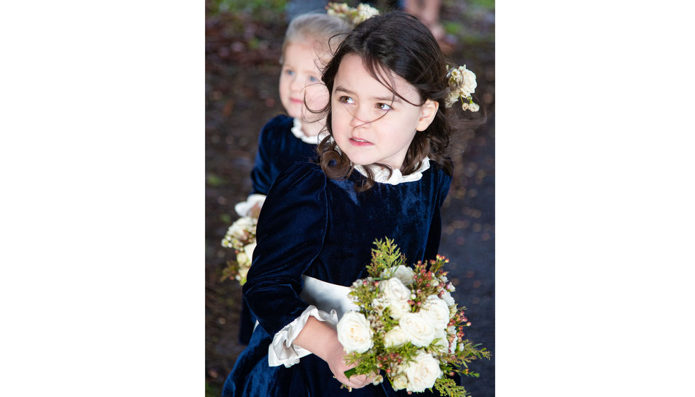 The flower girls wore little navy dresses with a little white frill at the neck and at the wrists.